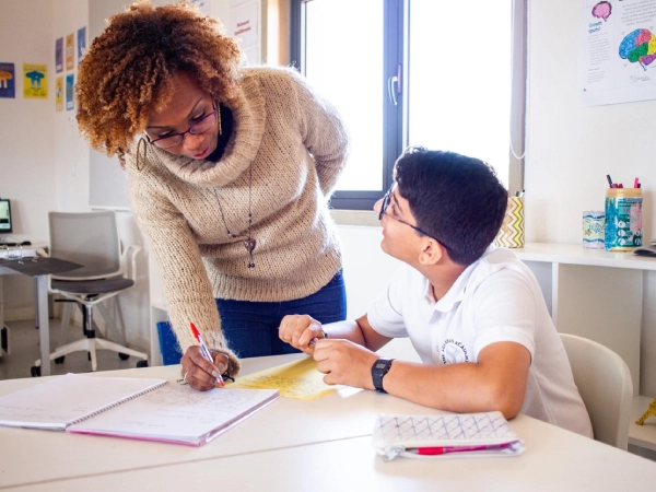 AKA Maputo teacher with a student inside a classroom.